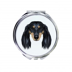 Uno specchio tascabile con un cane Bassotto longhaired. Una nuova collezione con il cane geometrico
