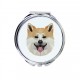 Uno specchio tascabile con un cane Akita. Una nuova collezione con il cane geometrico