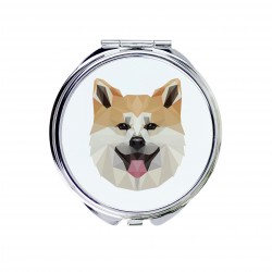 Un espejo de bolsillo con un perro Akita inu. Una nueva colección con el perro geométrico