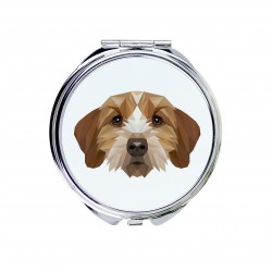 Un espejo de bolsillo con un perro Basset leonado de Bretaña. Una nueva colección con el perro geométrico