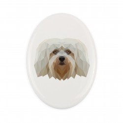 A ceramic tombstone plaque with a Havanese dog. Geometric dog