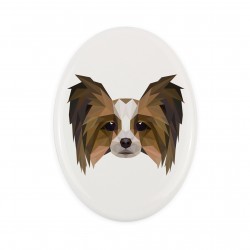 A ceramic tombstone plaque with a Papillon dog. Geometric dog